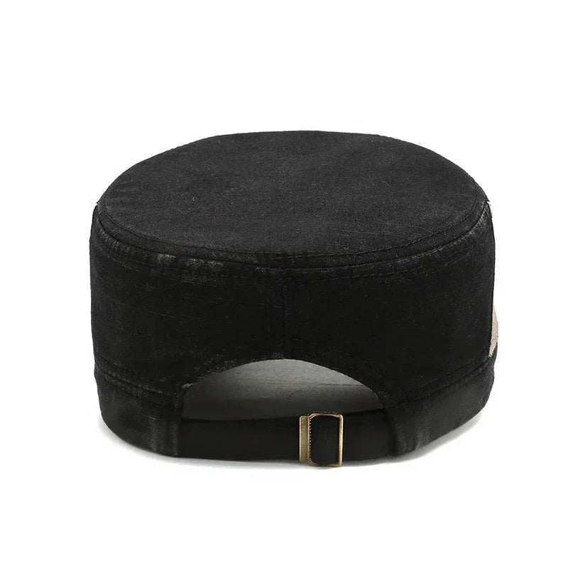 Black military-style cap with adjustable brass buckle strap on white background