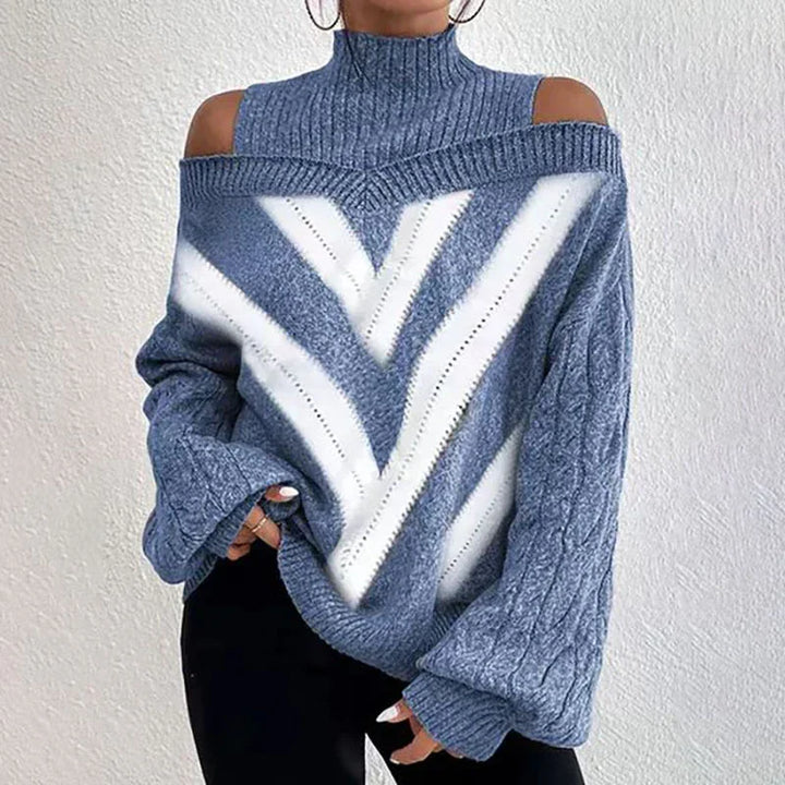 Woman wearing blue and white chevron knit off-shoulder sweater with high neck and balloon sleeves