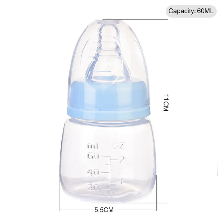 Clear 60ml baby feeding bottle with blue cap and measurement markings in ml and oz
