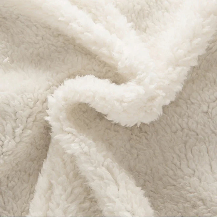 Close-up of soft, white fluffy fleece fabric with a cozy, textured surface