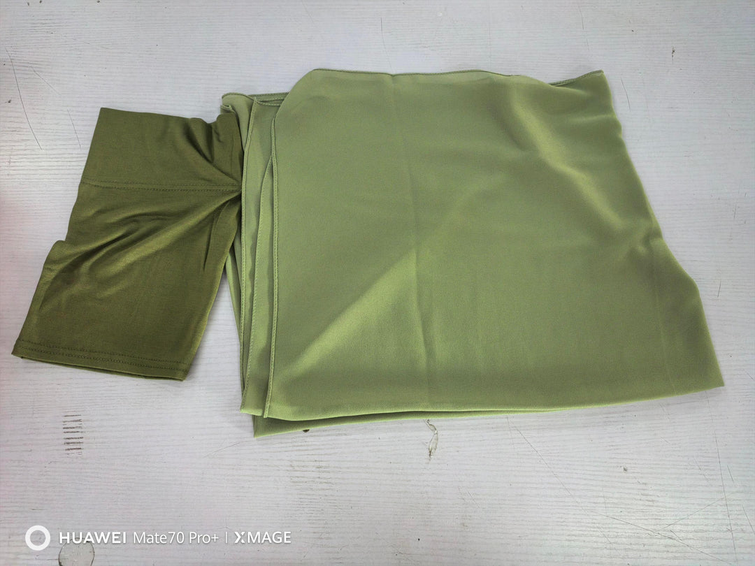 Folded olive green fabric with smooth texture on a white surface