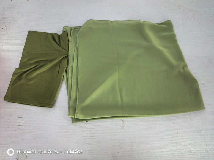 Folded olive green fabric with smooth texture on a white surface