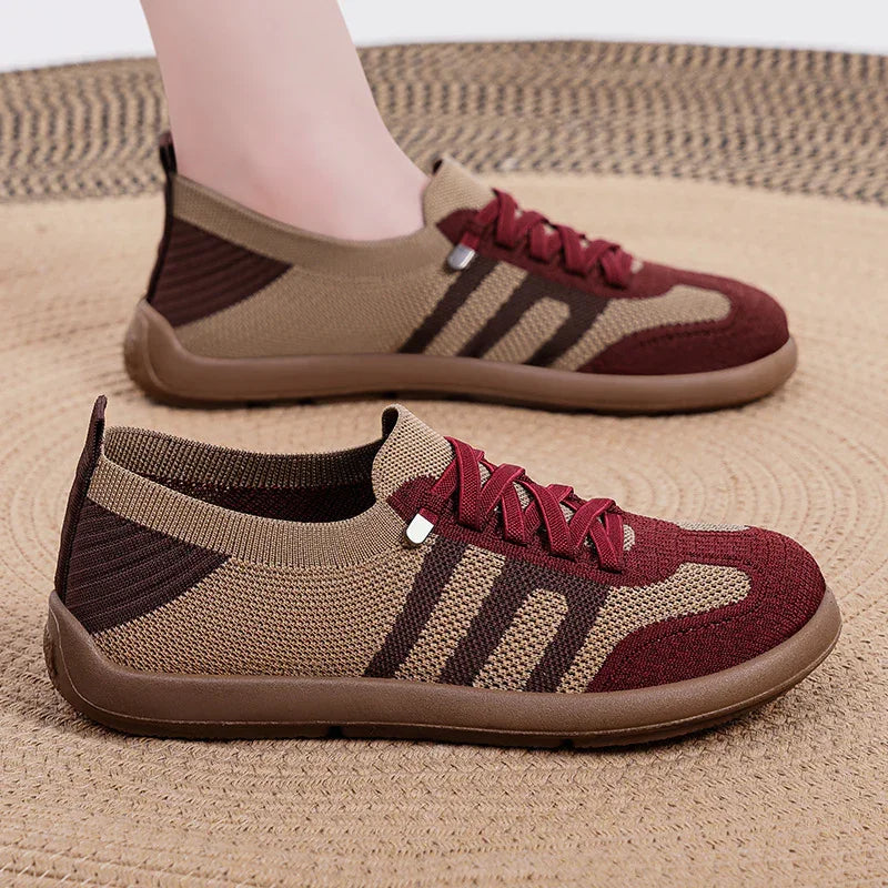 Brown and burgundy knitted casual sneakers with three dark stripes on beige woven rug