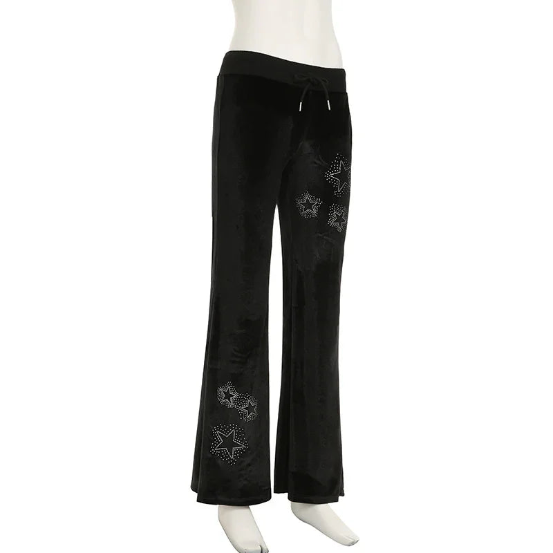 Black velvet wide-leg pants with studded star designs and drawstring waist on mannequin
