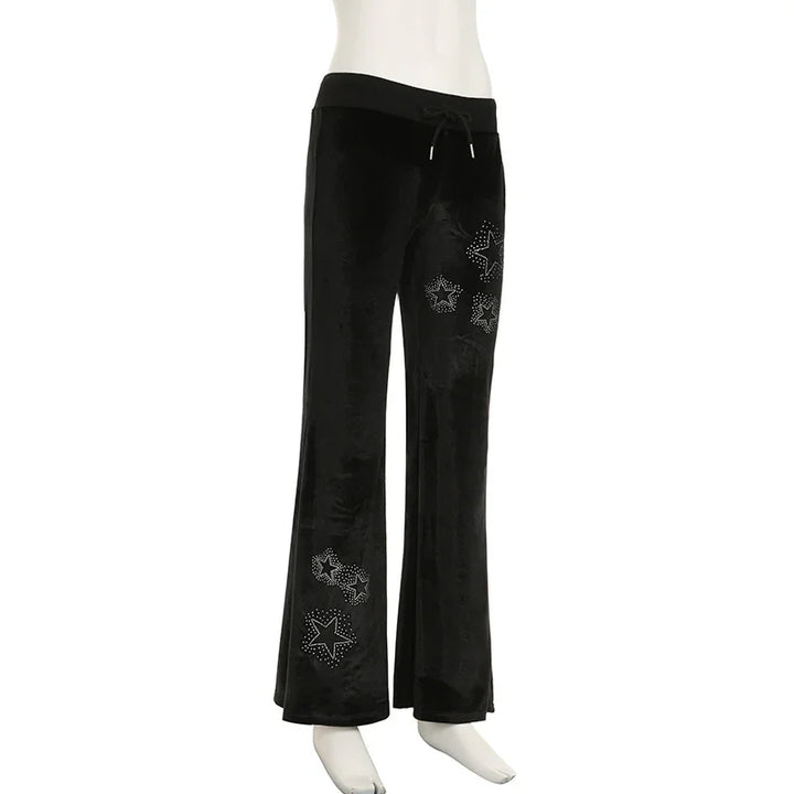 Black velvet wide-leg pants with studded star designs and drawstring waist on mannequin