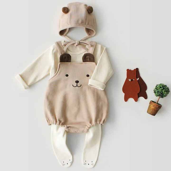 Baby beige bear-themed outfit with long sleeves, hat with ears, and white footed leggings on white background