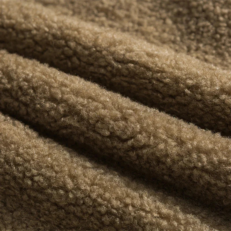 Close-up of soft brown sherpa fleece fabric texture with cozy, fluffy curls