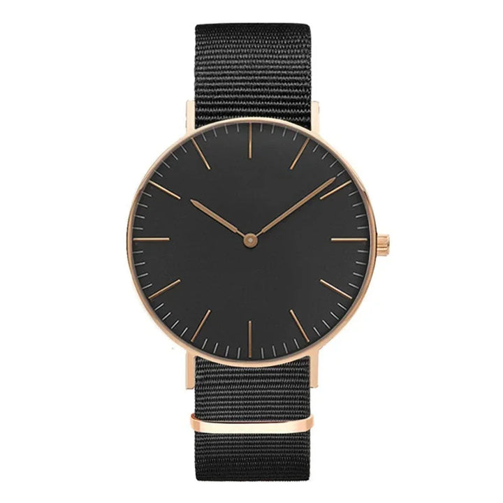 Minimalist wristwatch with black dial, rose gold case, and black nylon strap