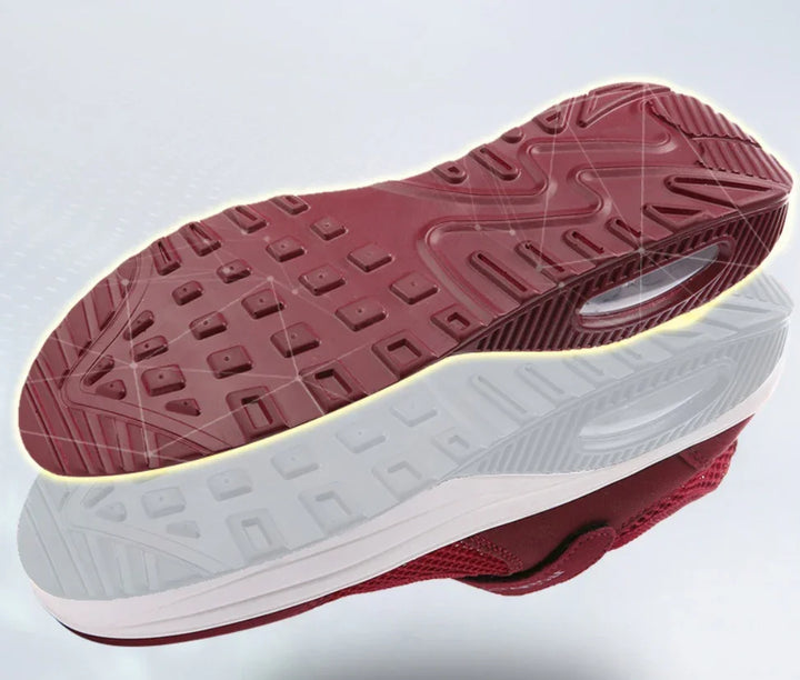 Red and white sneaker sole with detailed tread pattern and air cushion design