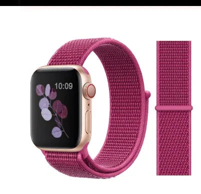 Gold Apple Watch with pink sport loop band displaying floral watch face at 10:09