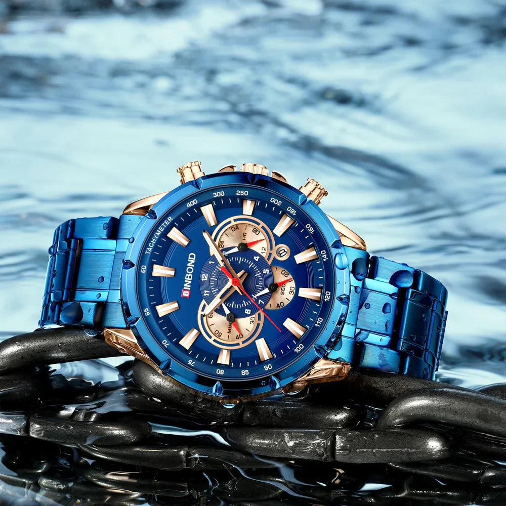 Blue BINBOND tachymeter wristwatch with gold accents on metal chain with water droplets