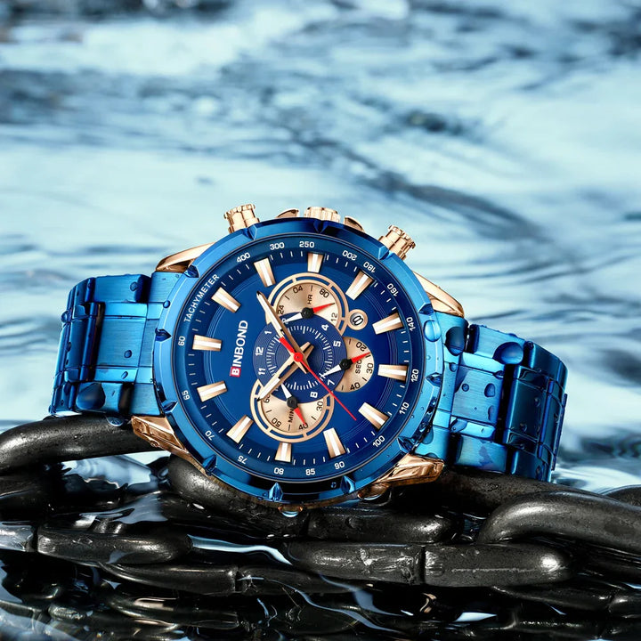 Blue BINBOND tachymeter wristwatch with gold accents on metal chain with water droplets