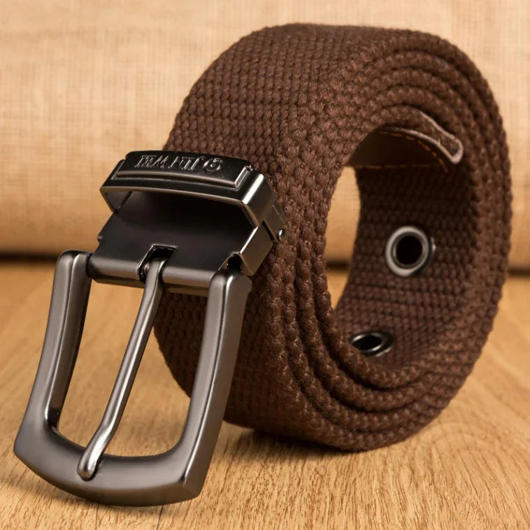 Brown woven fabric belt with black metal buckle on wooden surface