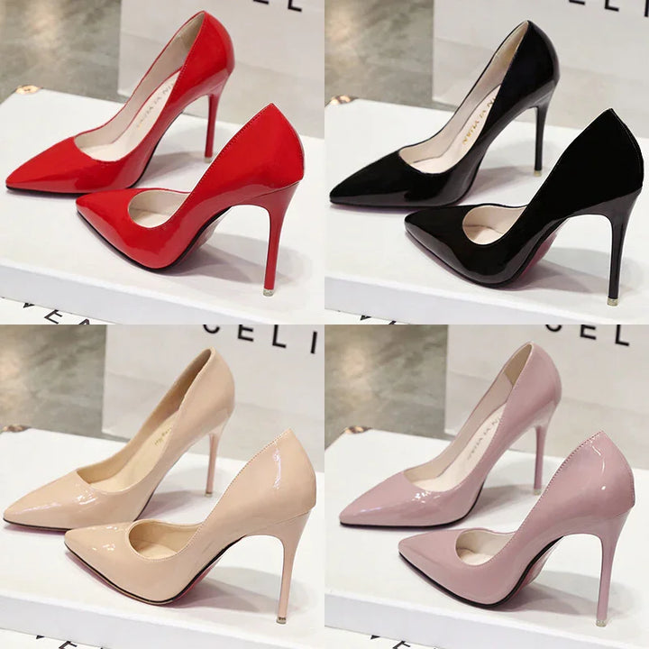 Glossy high-heeled pointed-toe pumps in red, black, beige, and pink on display boxes