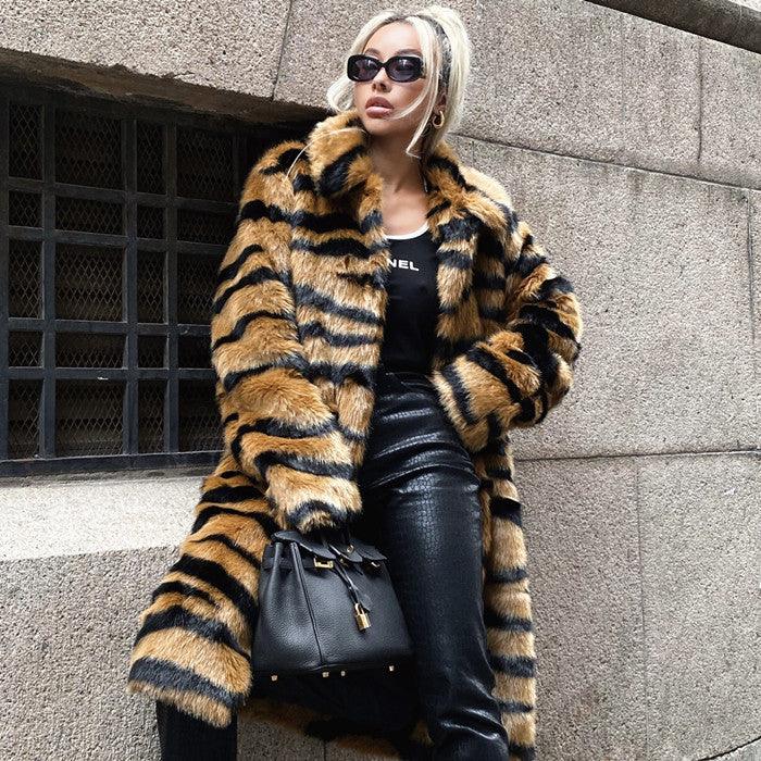 Stylish woman wearing a tiger print faux fur coat, black leather pants, black sunglasses, and holding a black handbag