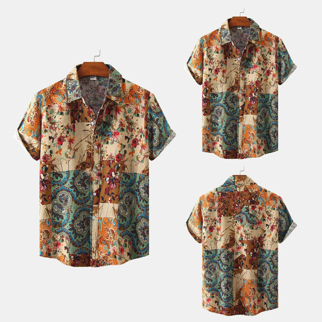 Short-sleeve button-up shirt with colorful floral and paisley patchwork pattern on wooden hanger
