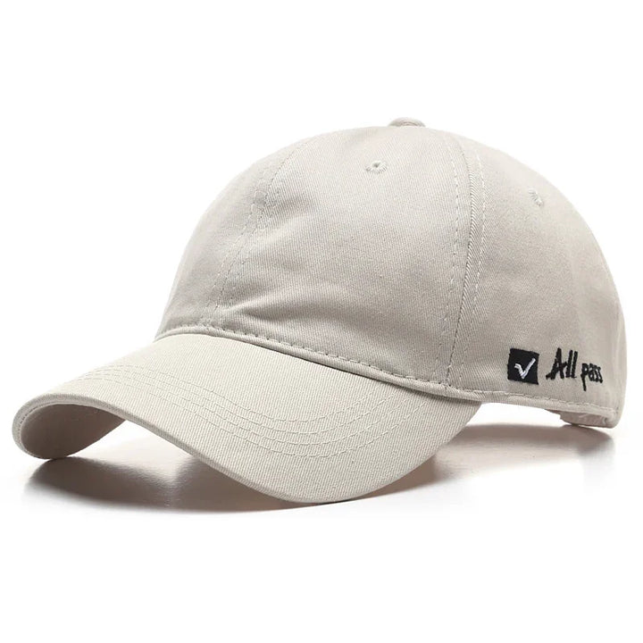 Beige cotton baseball cap with curved brim and black embroidered All pass logo on side