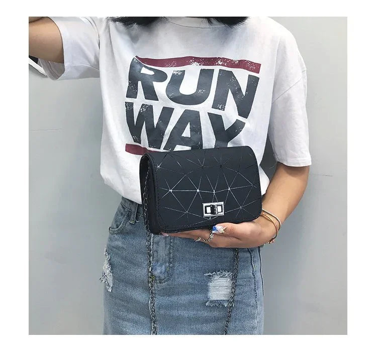 woman wearing white RUNWAY t-shirt and ripped denim skirt holding black geometric shoulder bag with chain strap