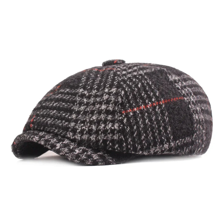 Black and grey plaid newsboy cap with subtle red accents on white background
