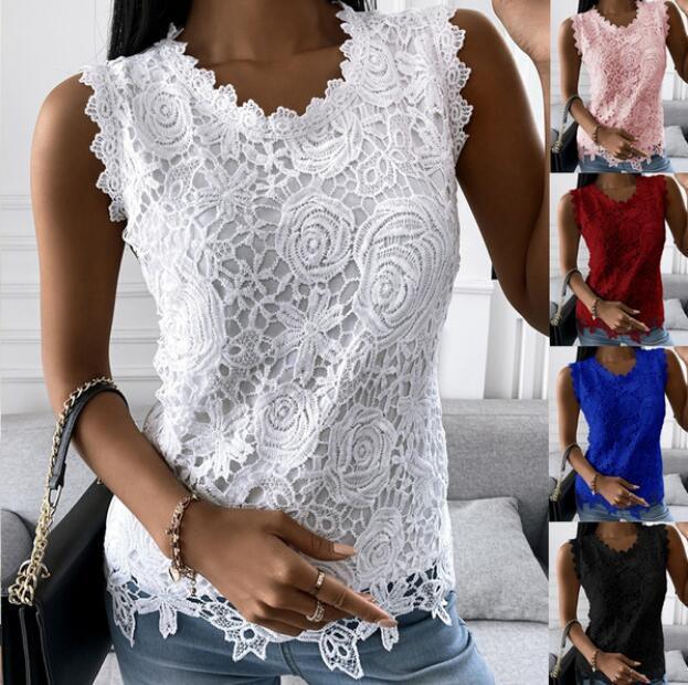Woman wearing white floral lace sleeveless top with scalloped neckline and hem, styled with blue jeans and bracelets