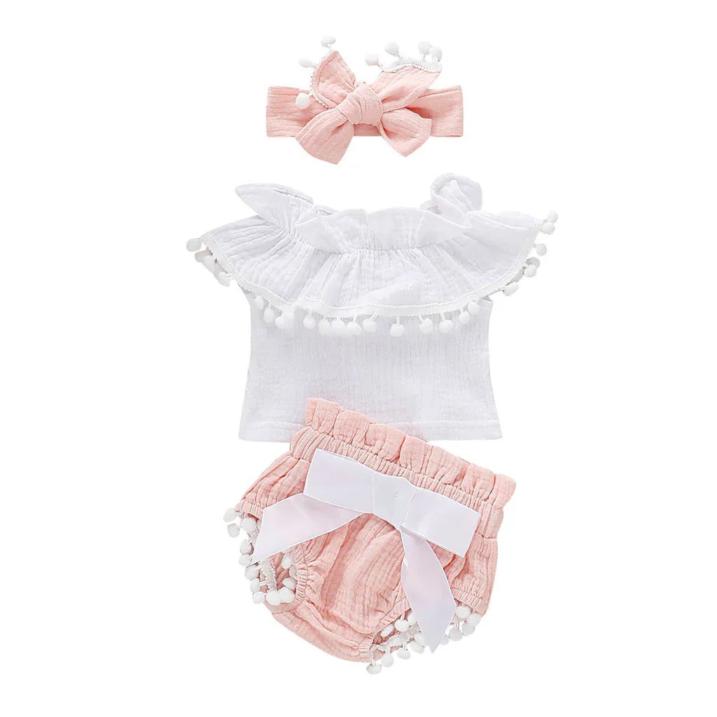 Baby girl summer outfit with white ruffled top, pink bloomers with bow, and matching pink headband