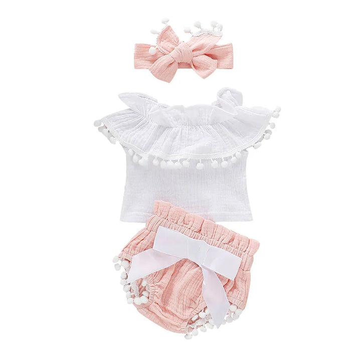 Baby girl summer outfit with white ruffled top, pink bloomers with bow, and matching pink headband