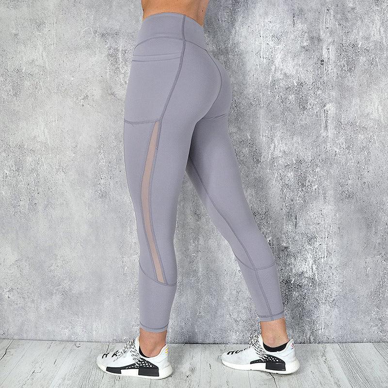 Gray high-waisted mesh panel leggings for women, athletic style, worn with white sneakers