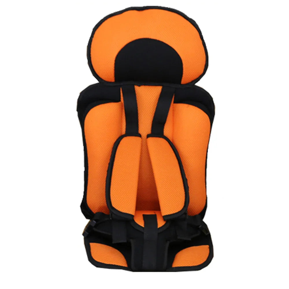 orange and black padded child car seat with safety harness and headrest