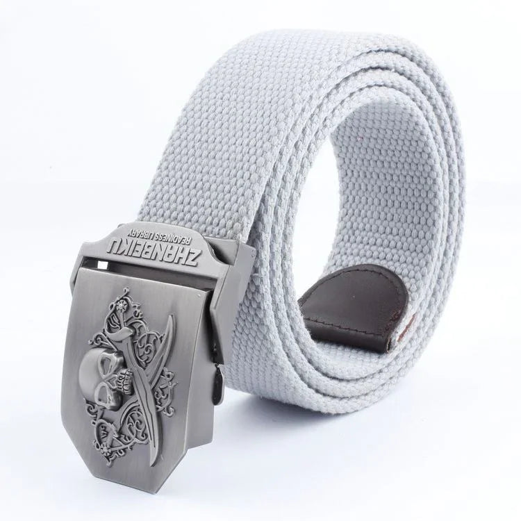 white canvas belt with metal buckle featuring skull and crossed swords design