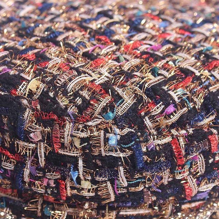 Close-up of colorful multicolored tweed fabric with intricate woven threads and textures
