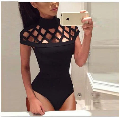 Woman taking mirror selfie wearing black bodysuit with lattice cutout design on chest and shoulders