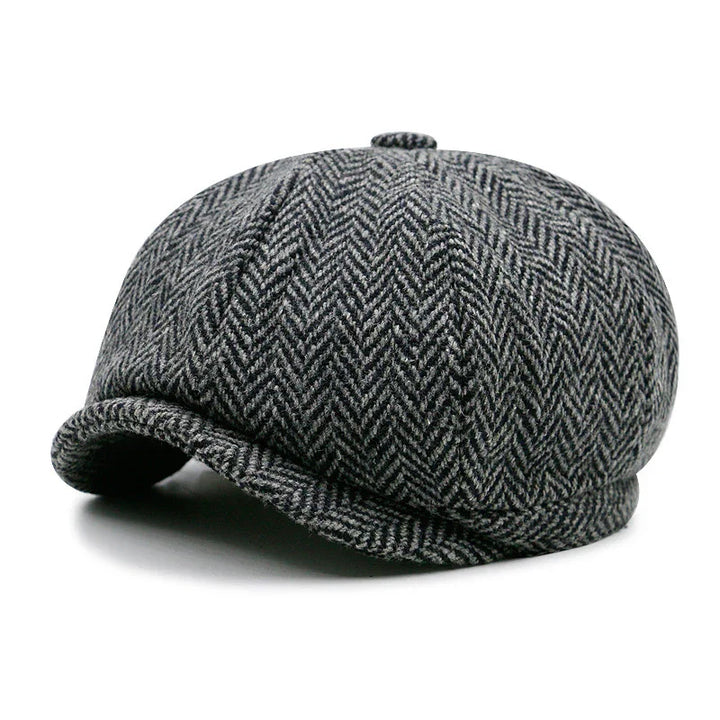 Gray herringbone tweed newsboy cap with rounded crown and small button on top