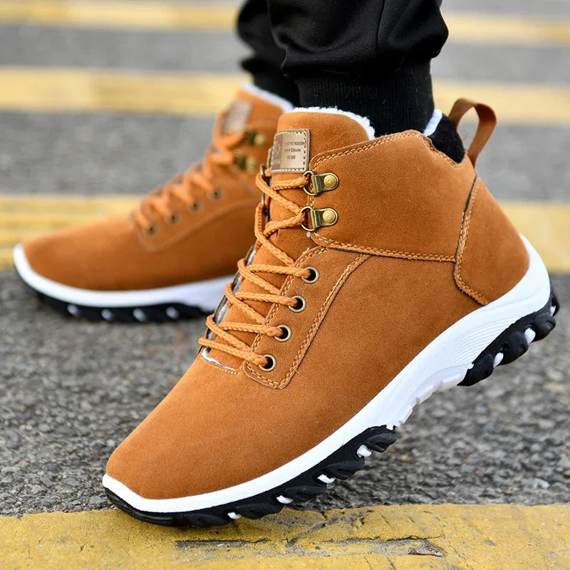 brown suede hiking boots with white and black rugged soles worn on asphalt with yellow lines
