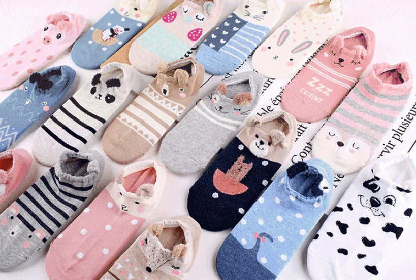 Colorful animal-themed and striped cozy ankle socks arranged on a white surface with soft textures