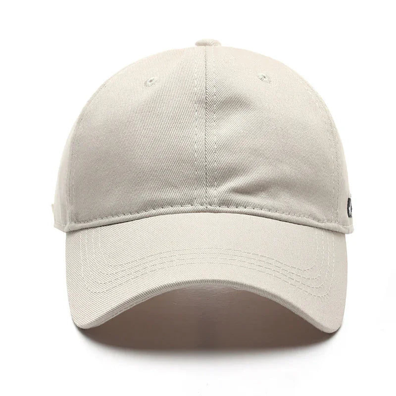 Beige cotton baseball cap with curved brim and stitched ventilation eyelets