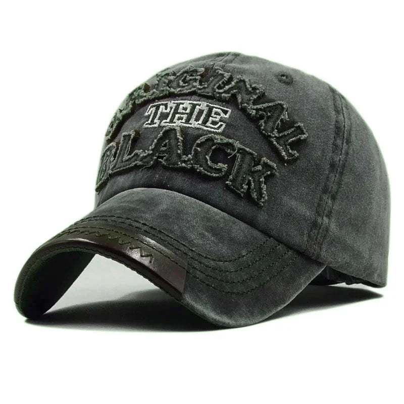 Faded black baseball cap with distressed embroidered text reading 'ORIGINAL THE BLACK' and stitched curved brim
