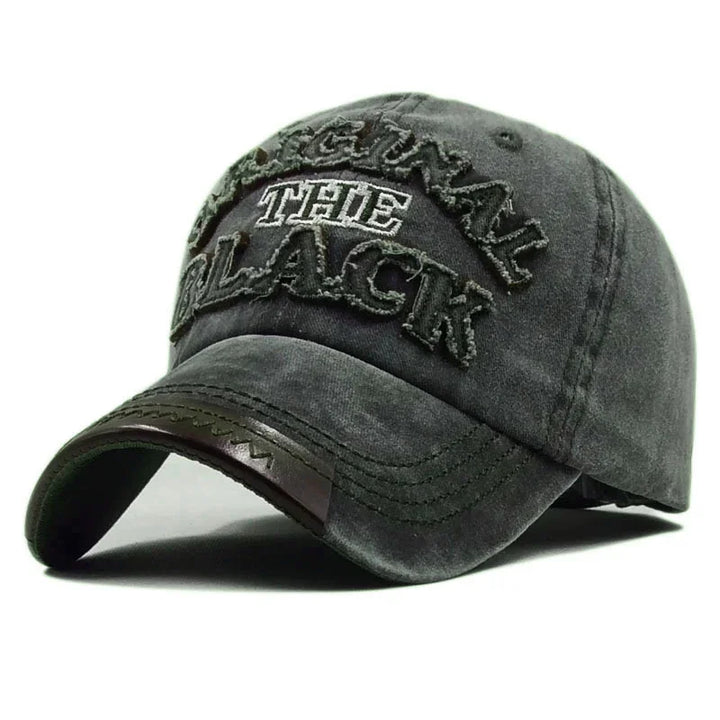 Faded black baseball cap with distressed embroidered text reading 'ORIGINAL THE BLACK' and stitched curved brim