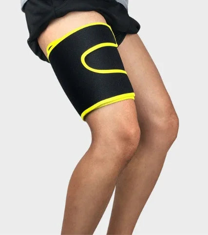 Person wearing a black and yellow thigh compression sleeve for support