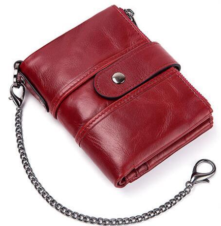 Red leather wallet with snap button and attached silver chain on white background