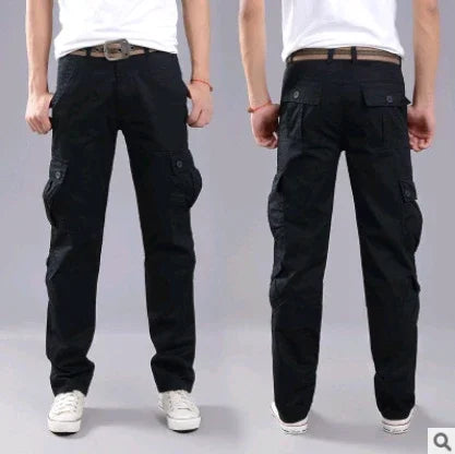 Front and back view of men's black cargo pants with multiple pockets, worn with white sneakers and a white t-shirt