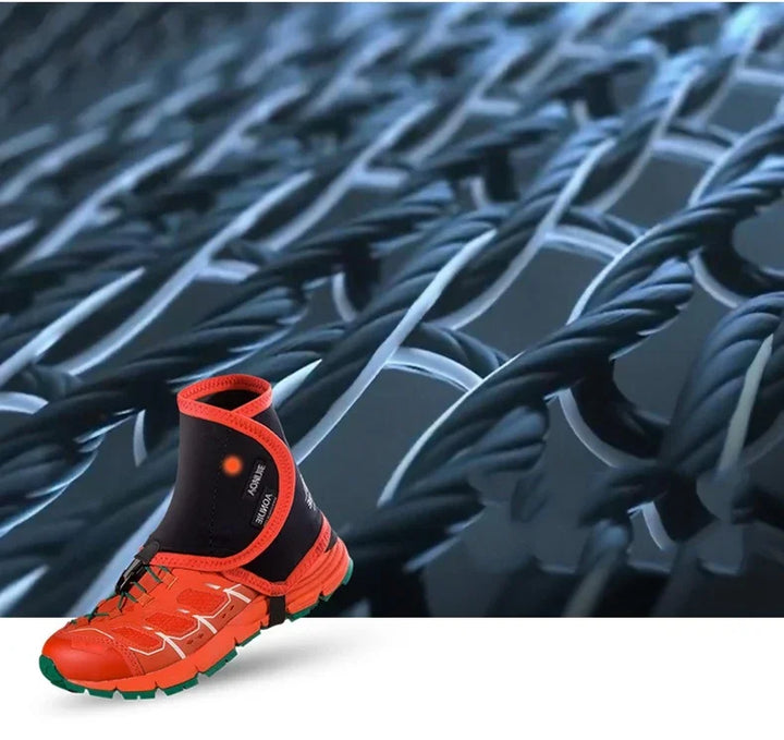 Close-up of orange sports shoe with integrated black ankle support sleeve against a twisted black wire mesh background