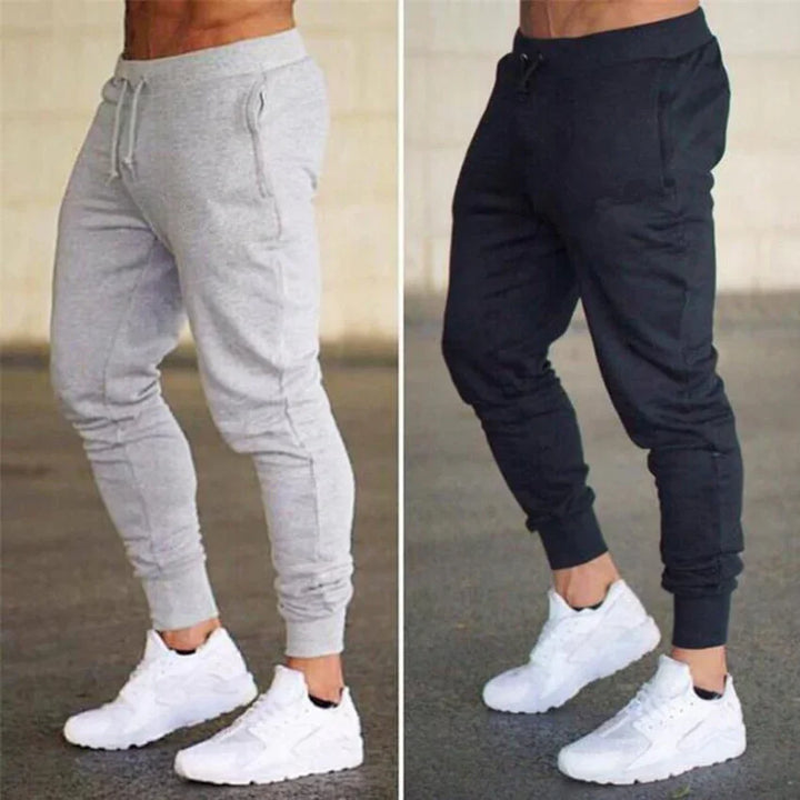 Men's athletic jogger pants in gray and black paired with white sneakers, sporty and casual wear