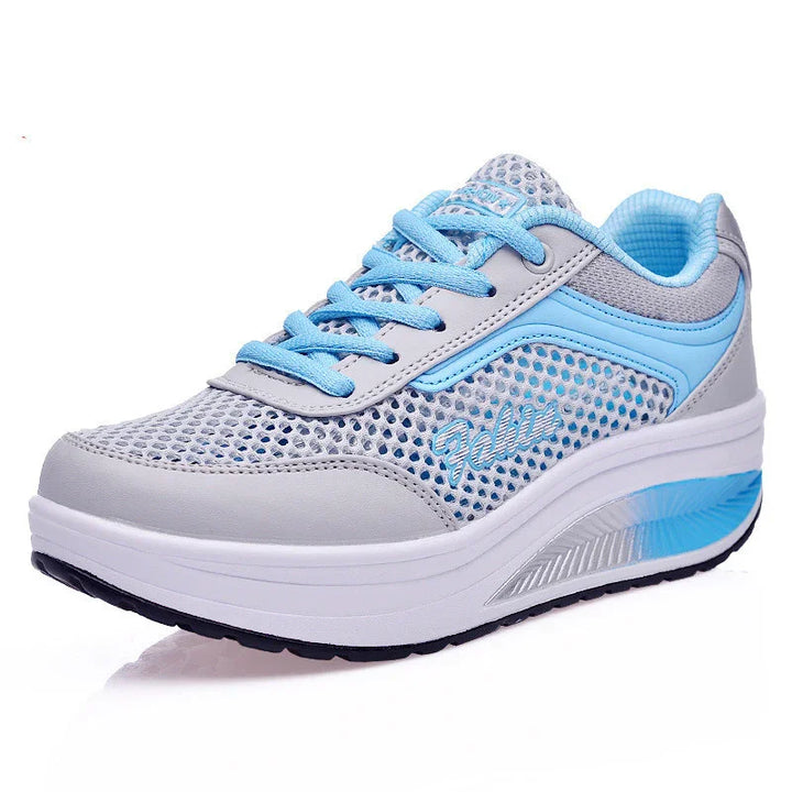 Light gray and blue breathable mesh athletic sneaker with cushioned sole and blue laces