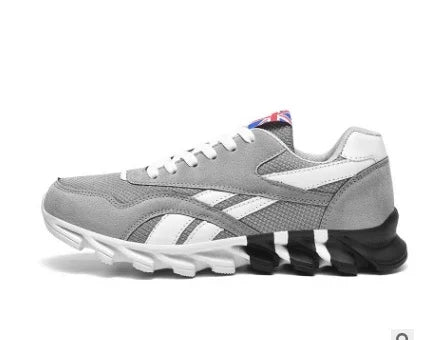 Side view of gray Reebok sneaker with white and black sole and Union Jack label on tongue