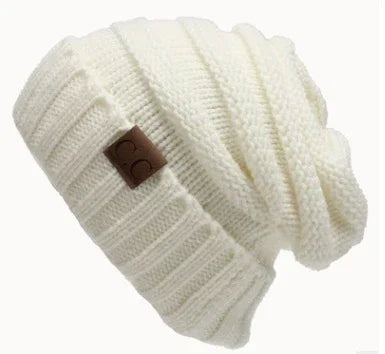 White knitted slouchy beanie hat with ribbed cuff and brown leather patch