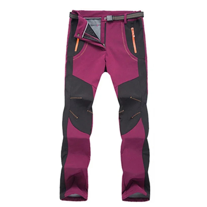 Purple and black outdoor hiking pants with orange zipper pockets and adjustable belt