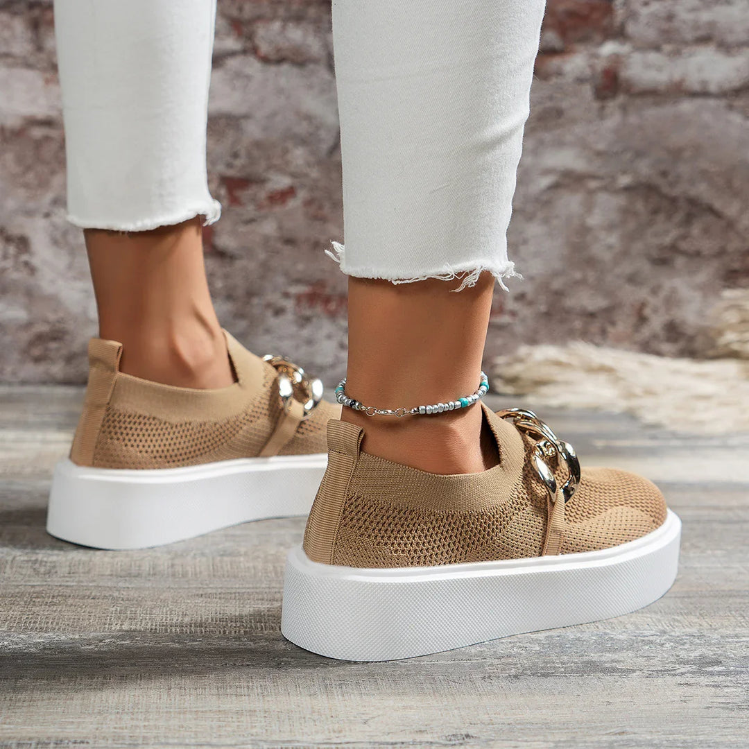 Beige knit slip-on platform sneakers with white soles worn with cropped white frayed jeans and beaded anklet