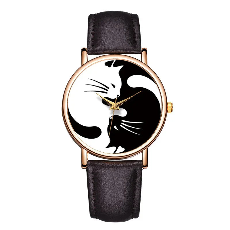 Wristwatch with black leather strap and gold case featuring yin-yang cats design on dial