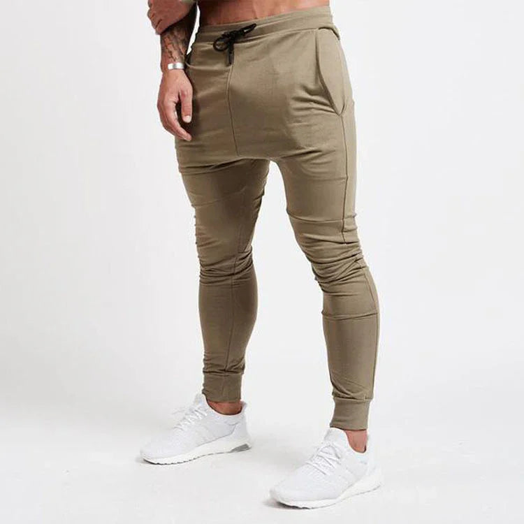 Man wearing slim fit beige jogger pants with drawstring, paired with white sneakers