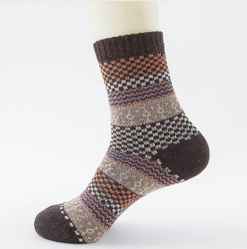Brown and beige patterned wool sock with ribbed cuff on white mannequin foot